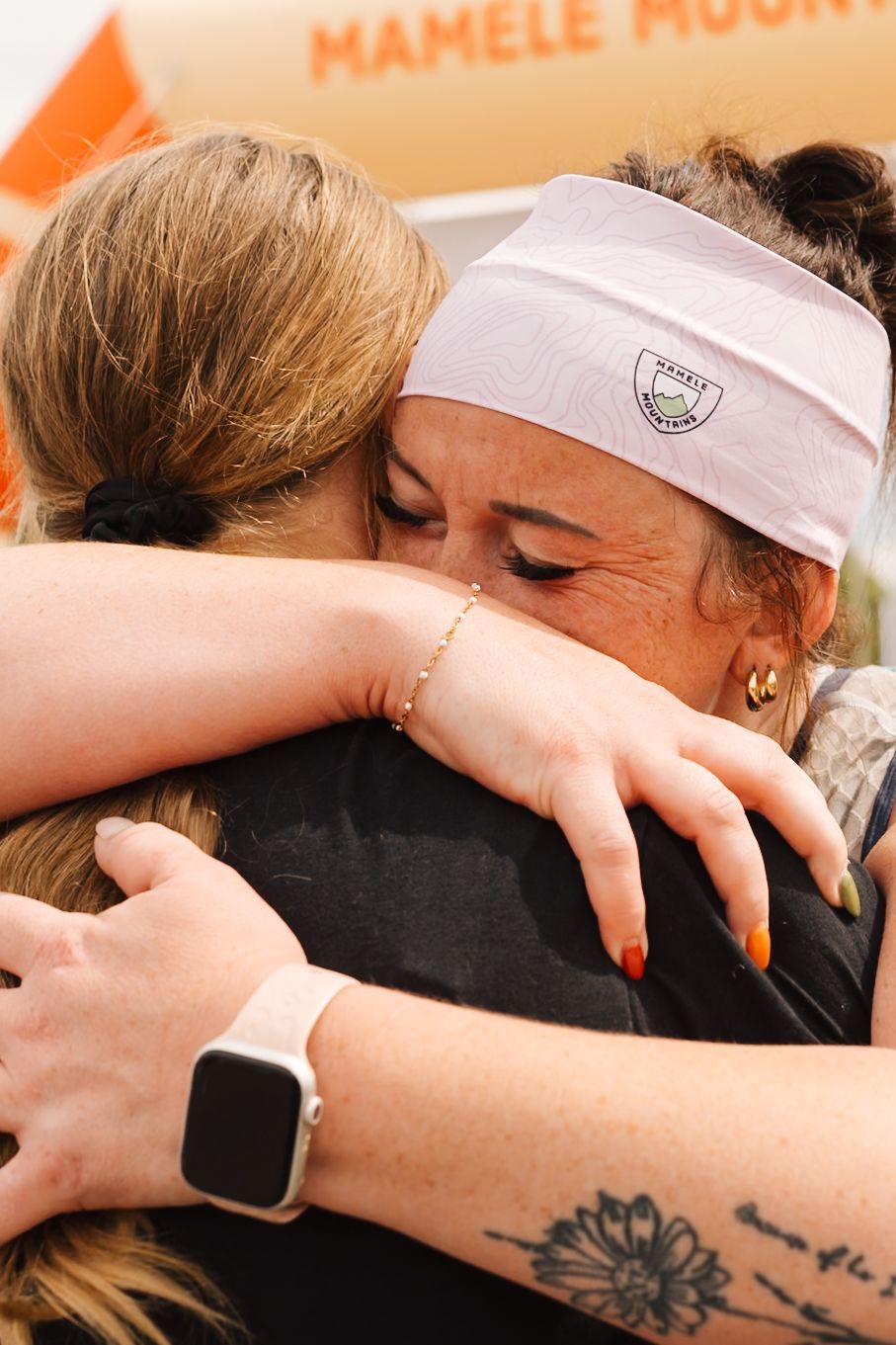 Two women hugging after finishing the race.